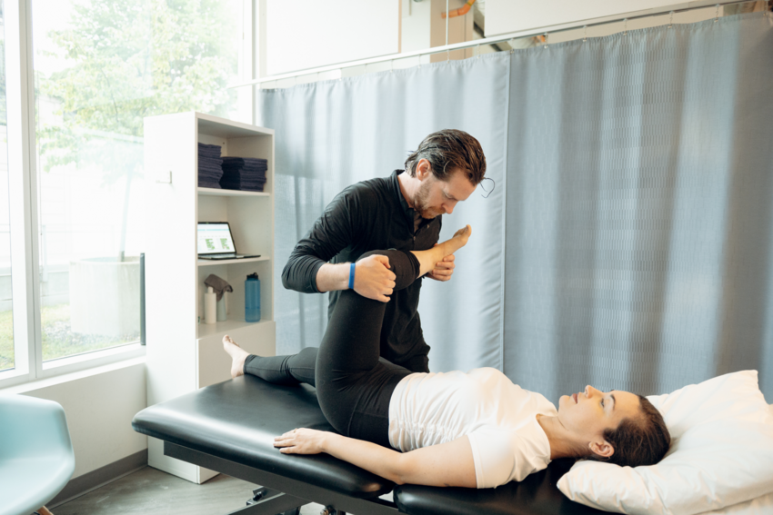 A practitioner treats a patient while using AI Scribe