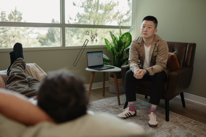 A new patient intake form displayed on a laptop beside a therapist and client in session.