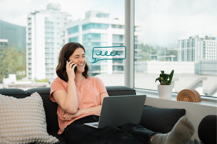 A seated practitioner on the phone with a client